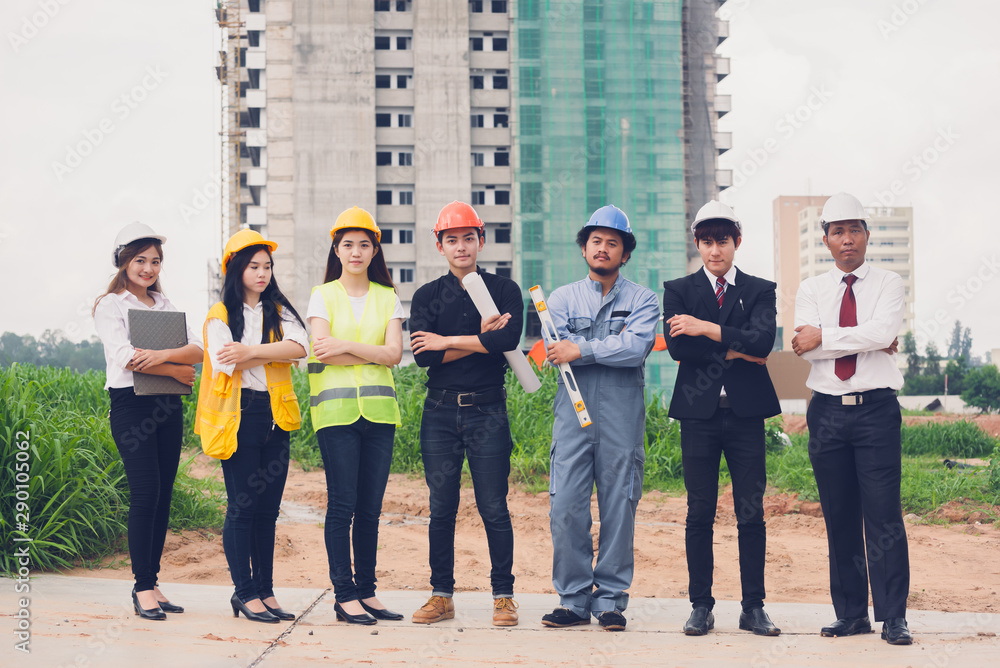 Happpy young Asian engineers ,construction site managers and businessmen in construction site