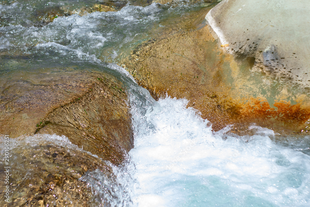Waterfall from ravine.waterfall from the mountain river. rapid current Waterfall from ravine.waterfall from the mountain river. rapid current