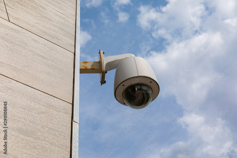 Overhead security camera on public building or office centre facade. Overhead security camera on public building or office centre facade.