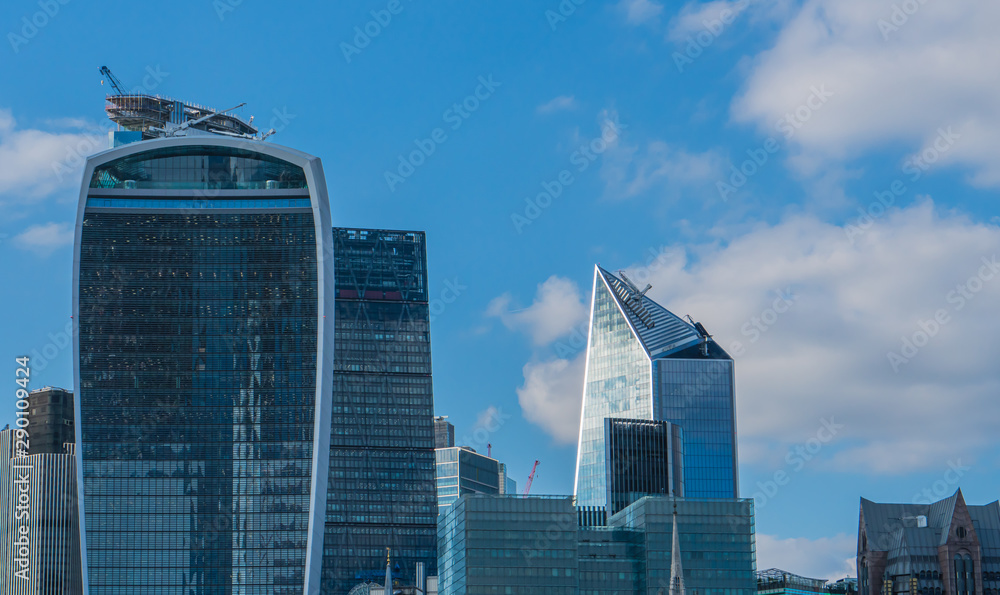 Skyscrapers of the City in London in the blue shade and sky.