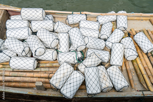 white buoys and netting lie in a boat on the quay at the port