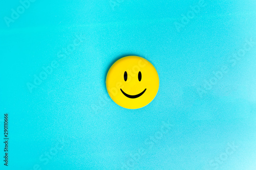 Positive Funny smiley face on a turquoise cardboard background. Copy space for advertising and texts