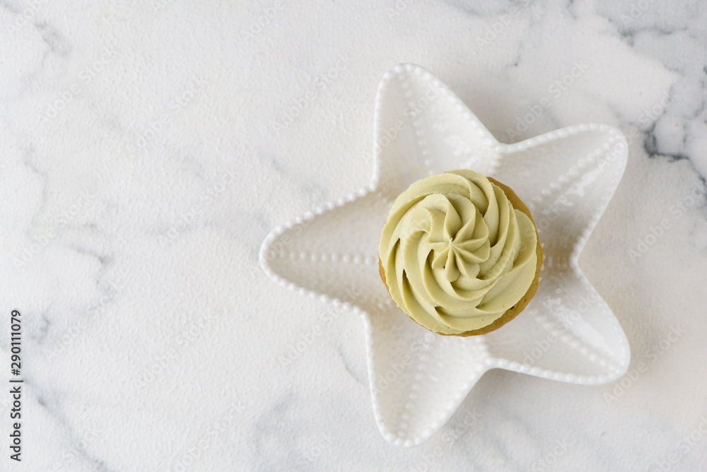 green matcha cupcake on white star plate green matcha cupcake on white star plate