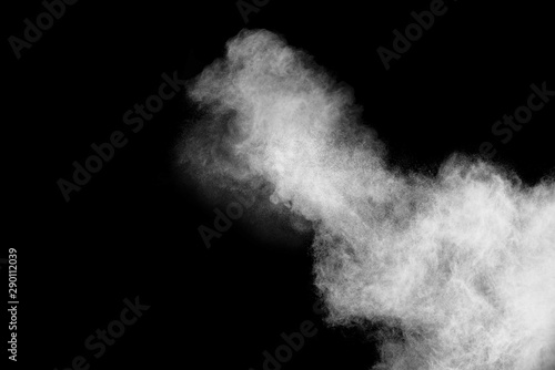 Freeze motion of white color powder exploding on dark background. 