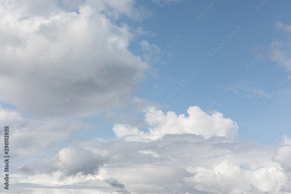 Blue clean sky background with white clouds.