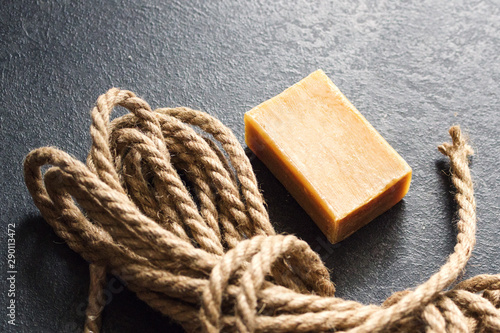 Rope and soap on a dark surface. Depiction of despair, suicide, death. photo