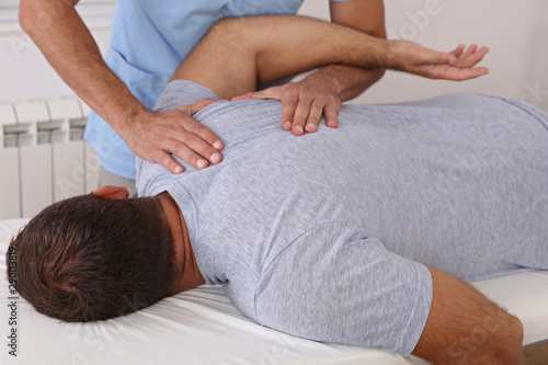 Osteopathy / Chiropractic treatment, Back pain relief. Physiotherapy for male patient, sport injury recovery