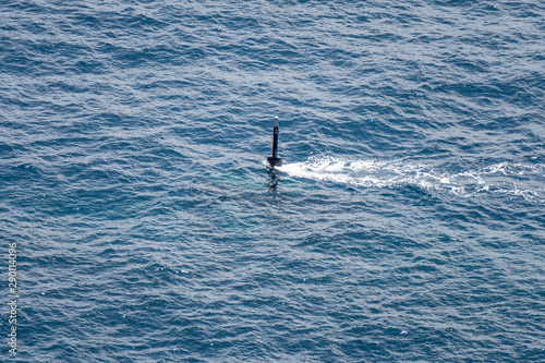Real periscope and radio transmission mast of the attack submarine  during the submarine sails in the periscope depth in the sea