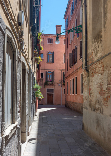 Narrow street with historic houses in Venice  Italy  in a beautiful sunny day.
