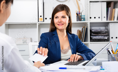 Businesswoman talking to female colleague