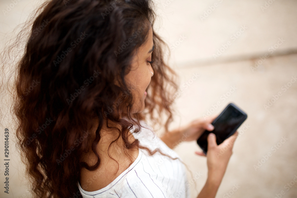 above portrait of beautiful young indian woman with cellphone above portrait of beautiful young indian woman with cellphone