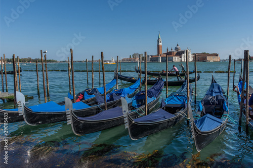 Gondolas near Saint Mark square (San Marco) and San Giorgio di Maggiore church in the background, in Venice, Italy