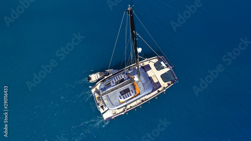 Aerial drone top down photo of luxury Catamaran sail boat docked in Mediterranean popular Aegean destination port with deep blue sea © aerial-drone