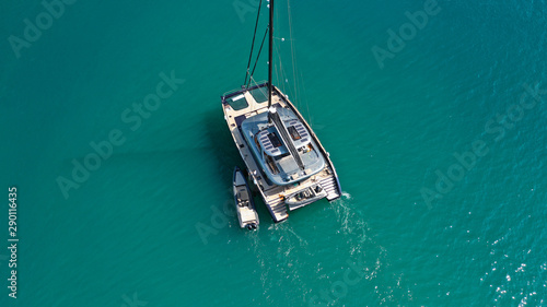 Aerial drone top down photo of luxury Catamaran sail boat docked in Mediterranean popular Aegean destination port with deep blue sea