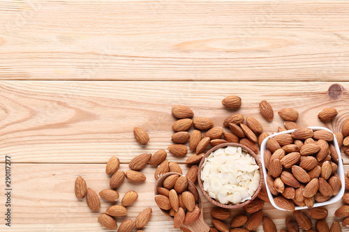 Almonds in bowls on brown wooden table