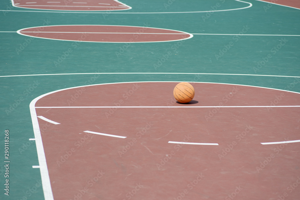 Fototapeta premium Basketball on empty basketball court