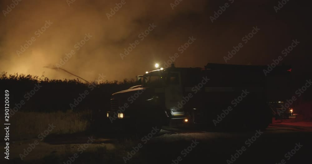 Fire truck with flashing lights on. Fire truck on background of burning ...