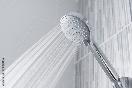 Bathroom shower head spraying water  photo
