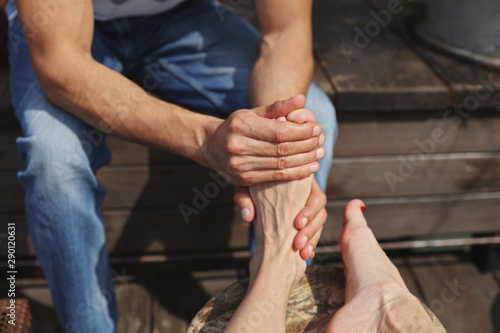 Happy couple goals, simple pleasures. Man massaging woman feet, two enjoying time together © dream@do