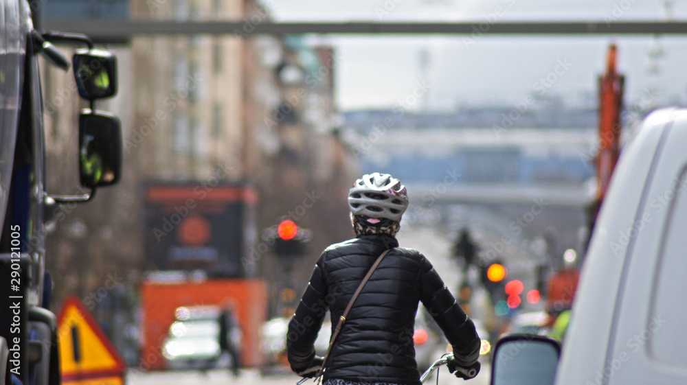 Woman driving a bycicle on streets of Stockholm