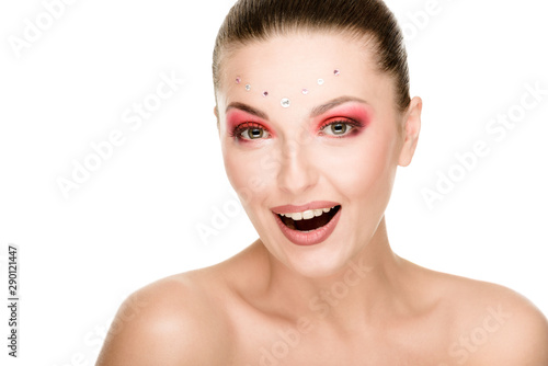 Art portrait of beautiful woman with opened mouth and rhinestones on her face