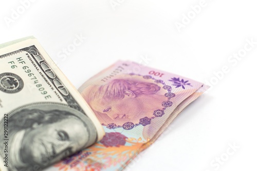 Argentinian peso and US dollar on white background. Money exchange, foreign economic affairs concept.