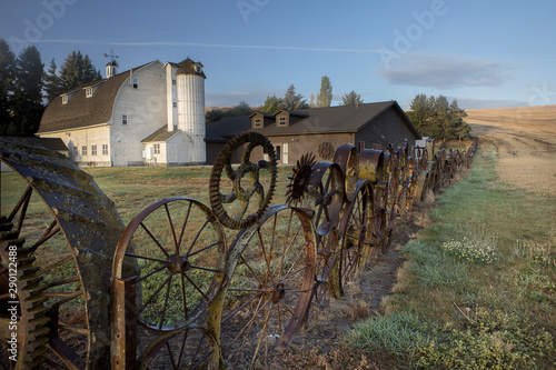 Gears and wheel as a fence in eastern Washington. photo