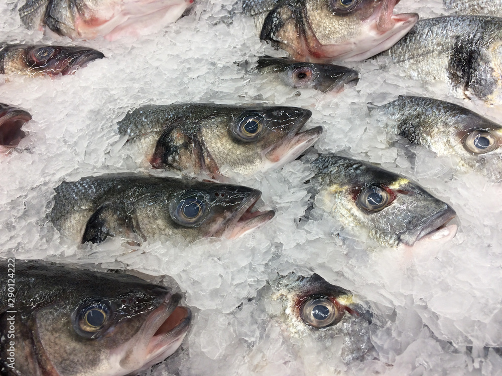 Fresh fish on ice in a box at supermarket for sale.