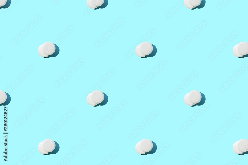 Pattern made of a lot of white round pills on blue. Pattern made of a lot of white round pills on blue.