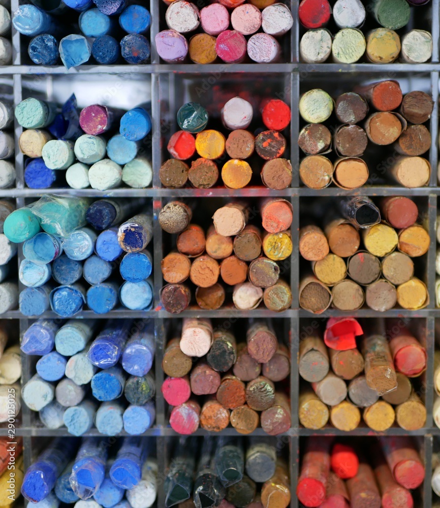 set of colorful pastels in a plastic box. objects for drawing. creativity. goods for artists. distribution by color tones. set of colorful pastels in a plastic box. objects for drawing. creativity. goods for artists. distribution by color tones.