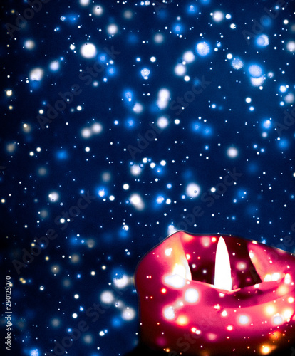 Photography Red holiday candle on blue sparkling snowing background, luxury branding design