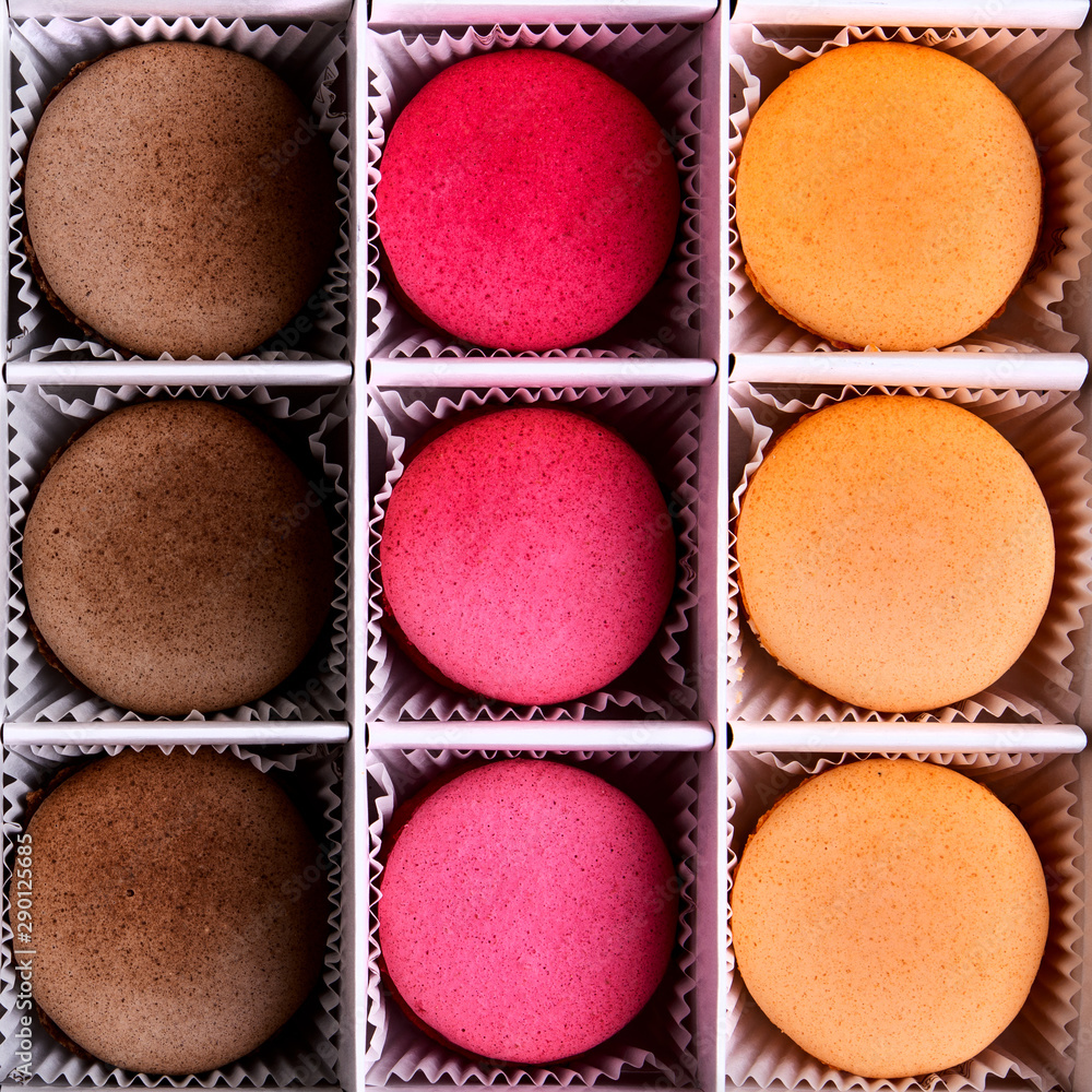 Set of colorful macarons in the box. The view from the top.Fresh multi-color macarons or macaroons Set of colorful macarons in the box. The view from the top.Fresh multi-color macarons or macaroons