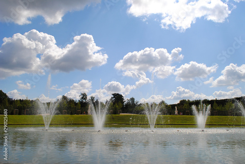 Fountain splashing water with a beautiful clouds on the sky