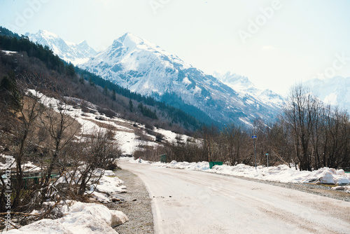 road in the Caucasus mountains in winter, snowy peaks and slopes