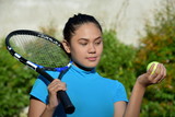 Cute Fit Asian Female Tennis Player With Tennis Racket