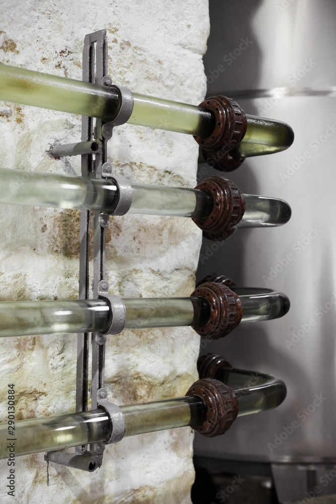 Fototapeta premium Old transparent glass pipeline system for wine