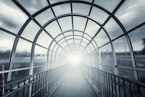 Light in the end of the metal and glass corridor.