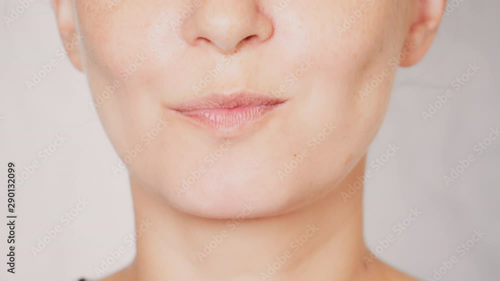 lower face caucasian female with freckles eats small cake portrait lady bites and chews lower face caucasian female with freckles eats small cake portrait lady bites and chews