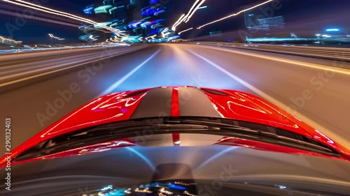 Drive by car in modern city timelapse, hyperlapse night. Camera is placed on roof the Red muscle car and level is horizontal.
