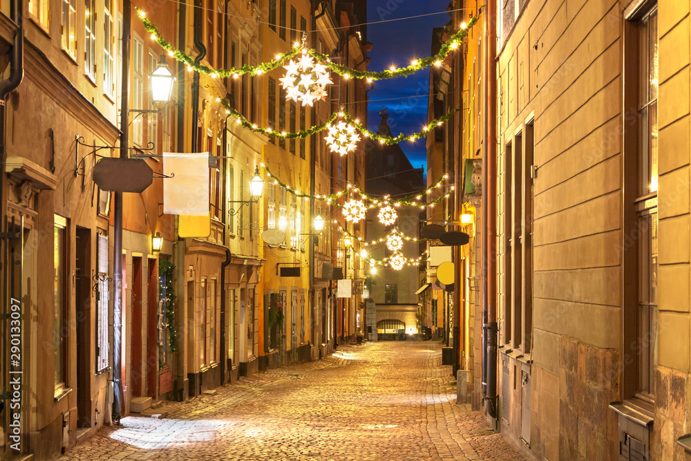 Street in Old Town (Gamla Stan) decorated for Christmas time at night, Stockholm, Sweden