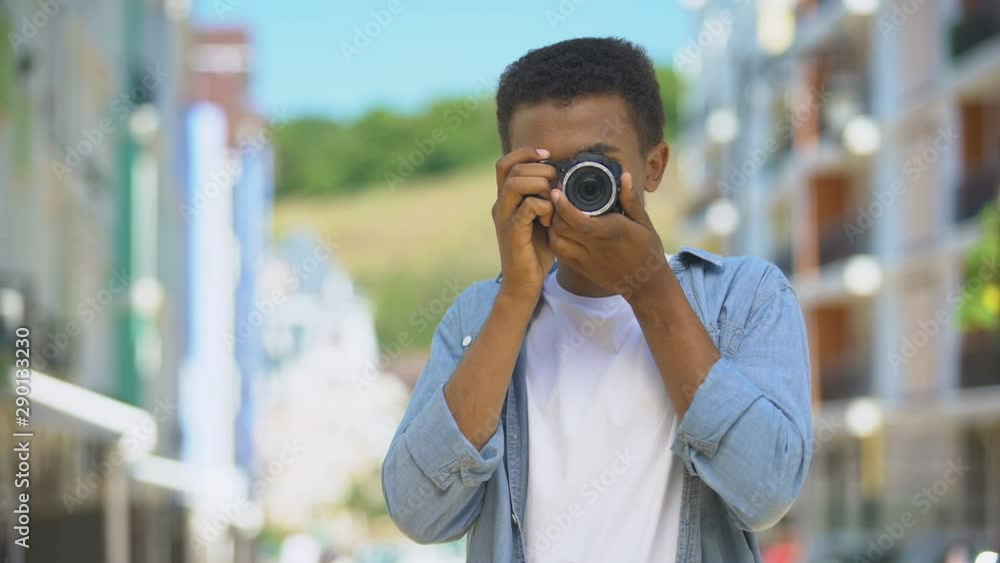 Young teen with camera making photos outdoor and smiling, hobby and rest Young teen with camera making photos outdoor and smiling, hobby and rest