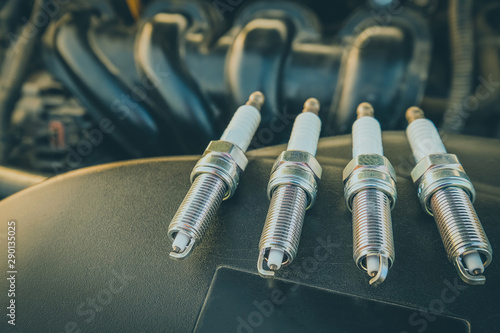 Photography replacing spark plugs in the car