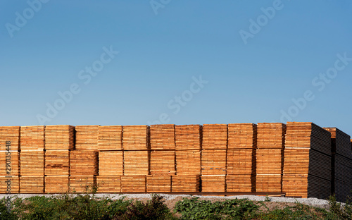 Lumber storage. Wood boards piles stored outdoor