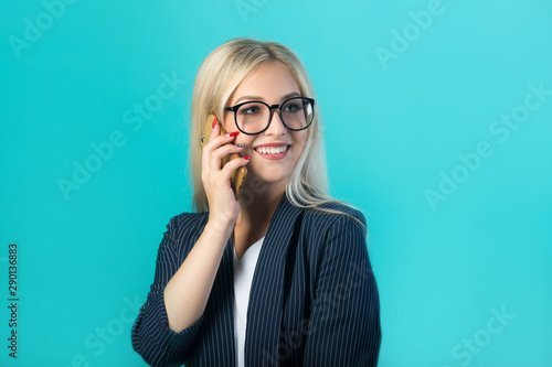 beautiful young woman in a black suit with glasses calls on the phone