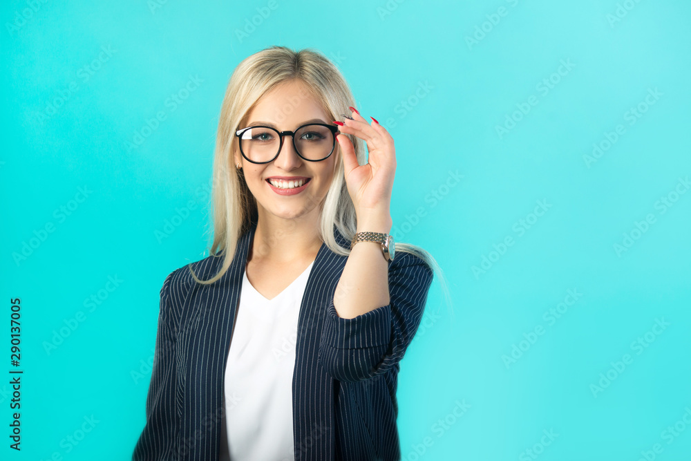 beautiful young woman in a black suit with glasses on a blue background beautiful young woman in a black suit with glasses on a blue background
