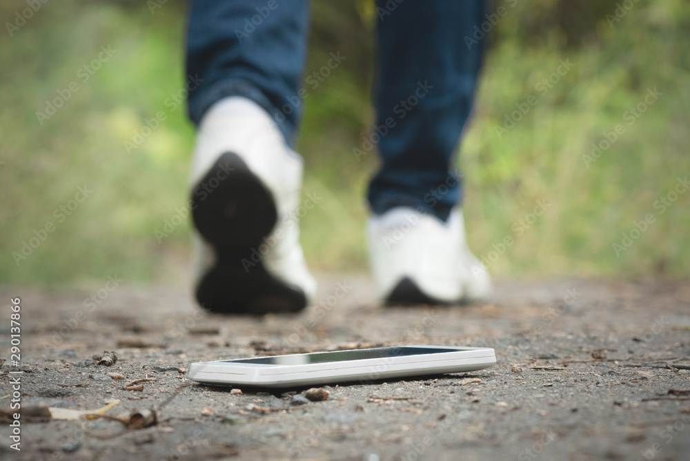 Lost mobile phone laying on a ground.