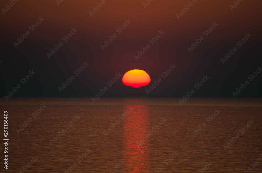 Sunset over sea on dark sky background Sunset over sea on dark sky background