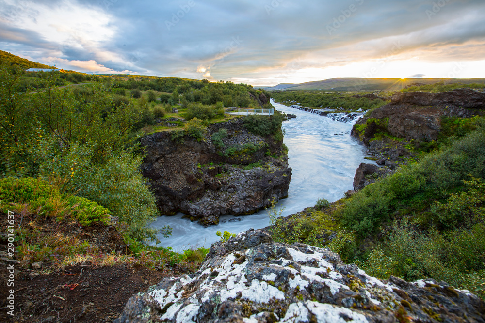Barnafoss, a yellow sunset on the river that falls from the waterfalls. Iceland Barnafoss, a yellow sunset on the river that falls from the waterfalls. Iceland