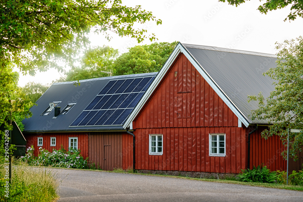 Old Swedish House with solar panel roof in country side Old Swedish House with solar panel roof in country side