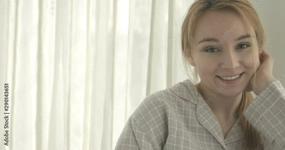 Awaking happy woman in pajamas looking at camera, in home. Copy space. Awaking happy woman in pajamas looking at camera, in home. Copy space.